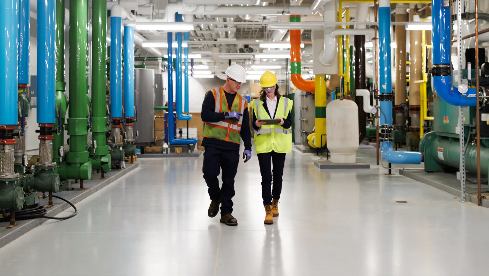 two JCI employees discussing about chillers