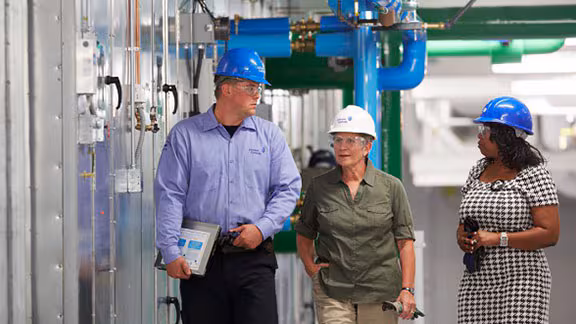people in factory with safety helmets